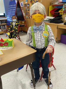A student dresses up for the 100th day of school 