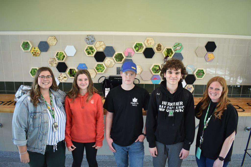 Agriculture and art students and teachers posing by new moss art wall