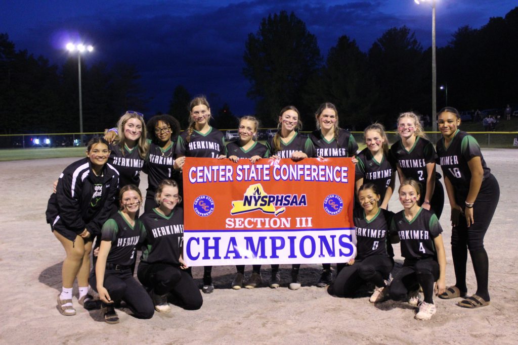 Softball champs posing with banner