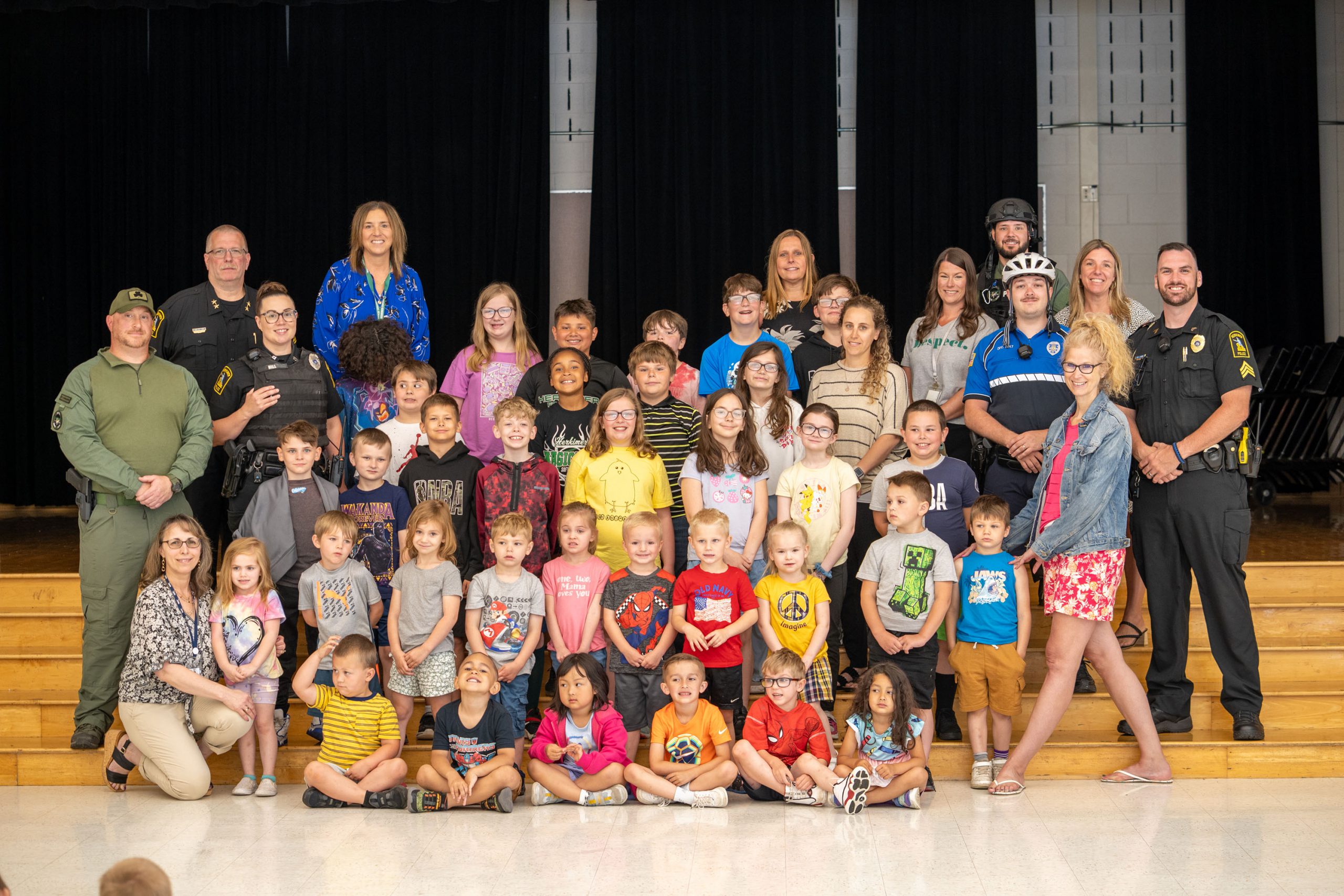 Herkimer students, teachers, administrators and police pose for a photo at assembly