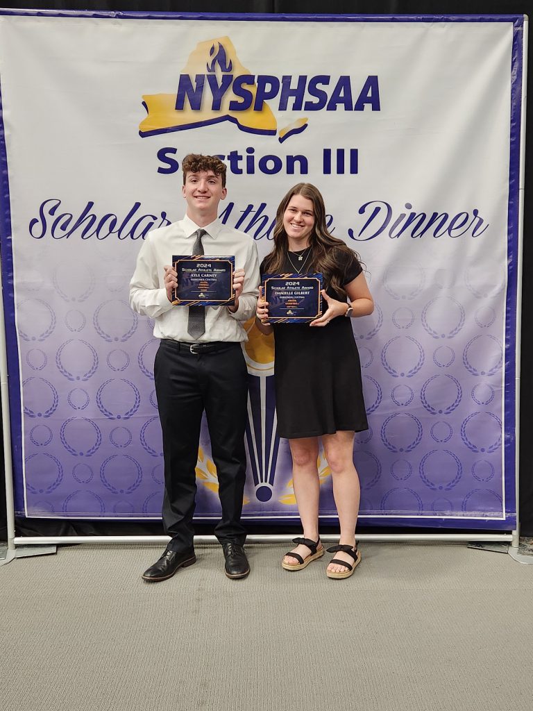 Two students holding scholar athlete plaques