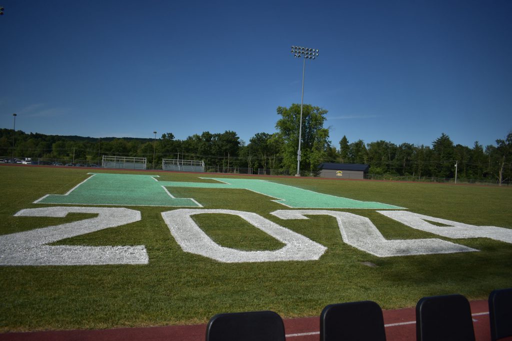 The athletic field displays "h" and "2024" on a sunny day.