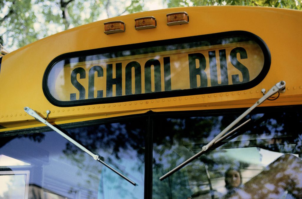 Front of a school bus with windshield and wipers.