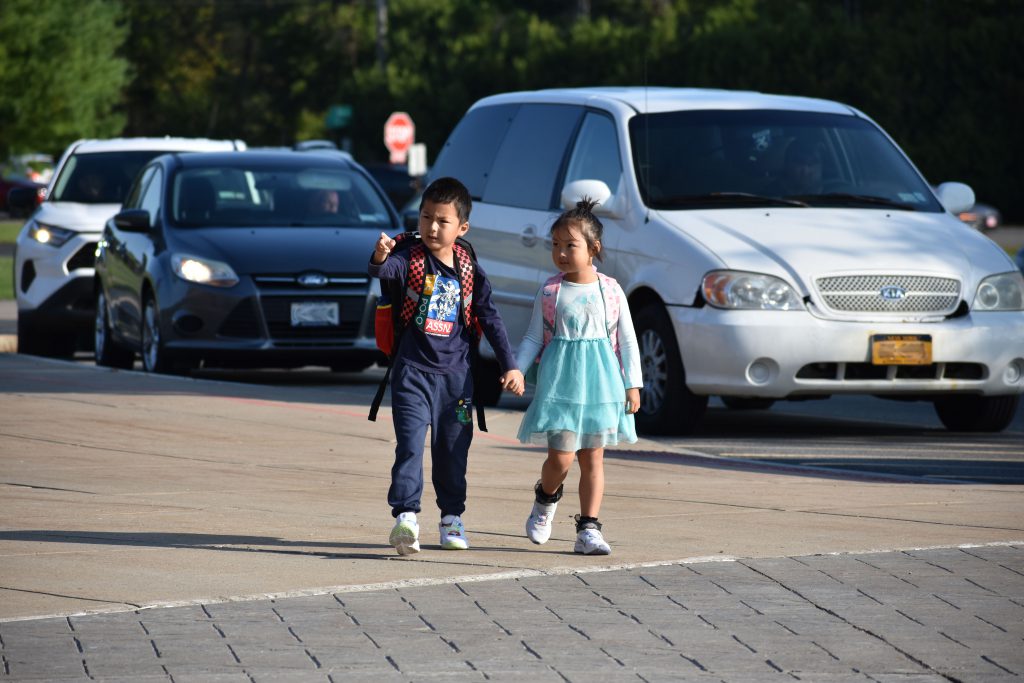 Two elementary students arriving on the first day of school