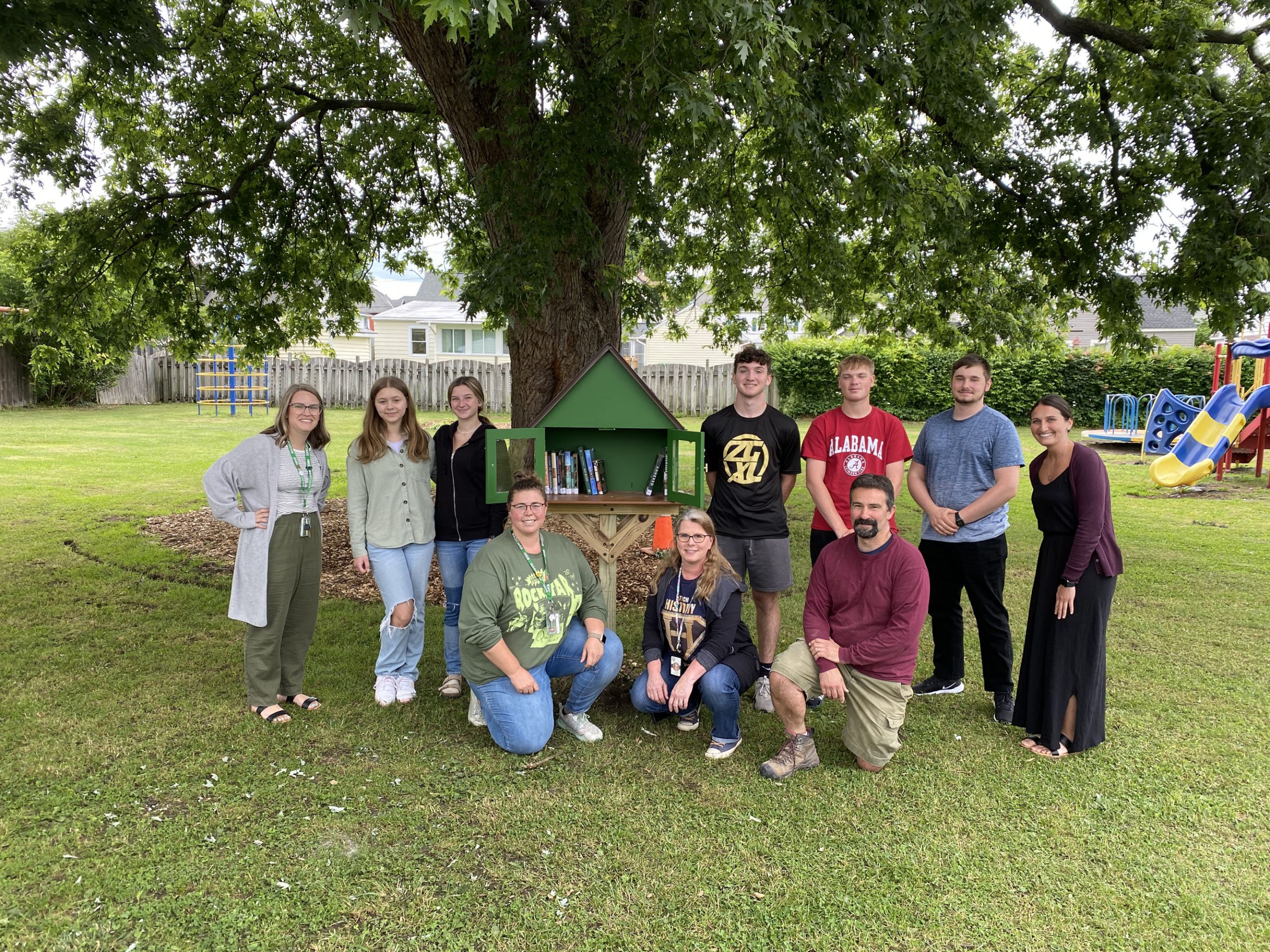 Students and staff pose together at Harmon Park