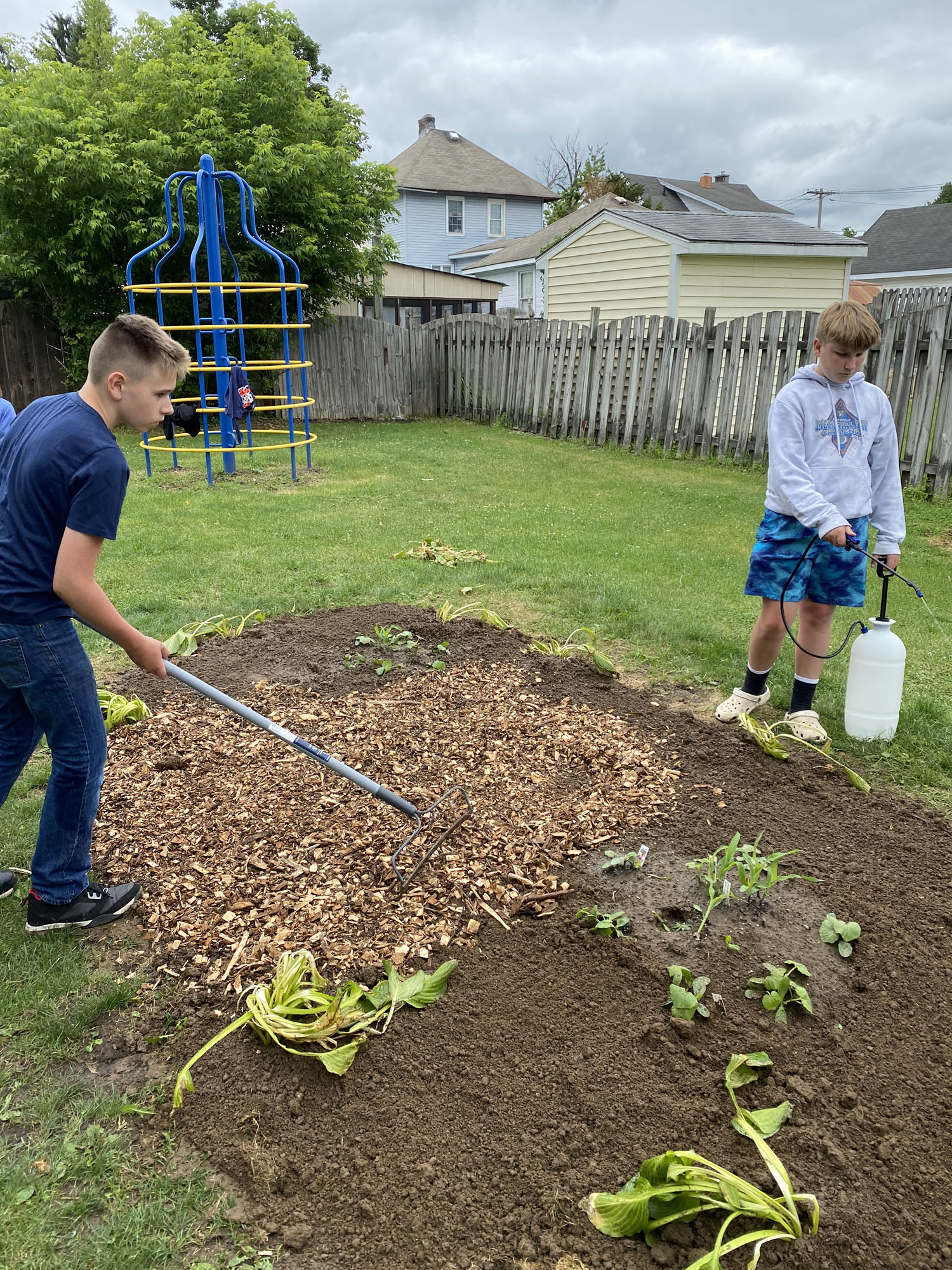 Two students gardening at Harmon Park