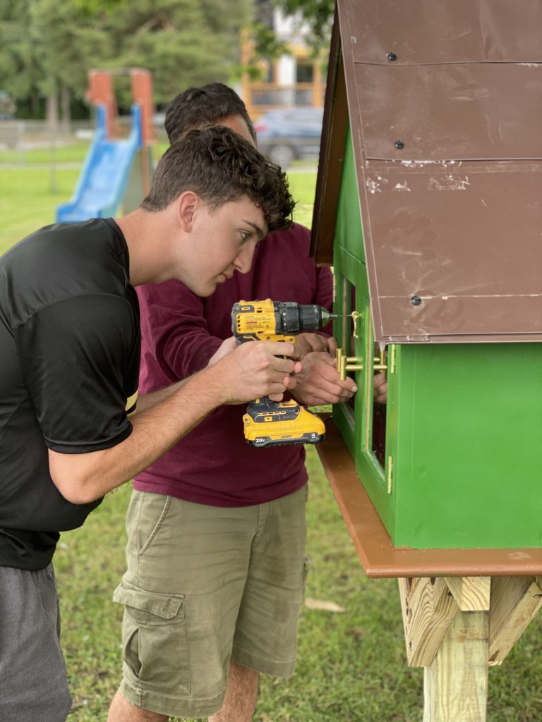 Student drilling to build Little Free Library at Harmon Park