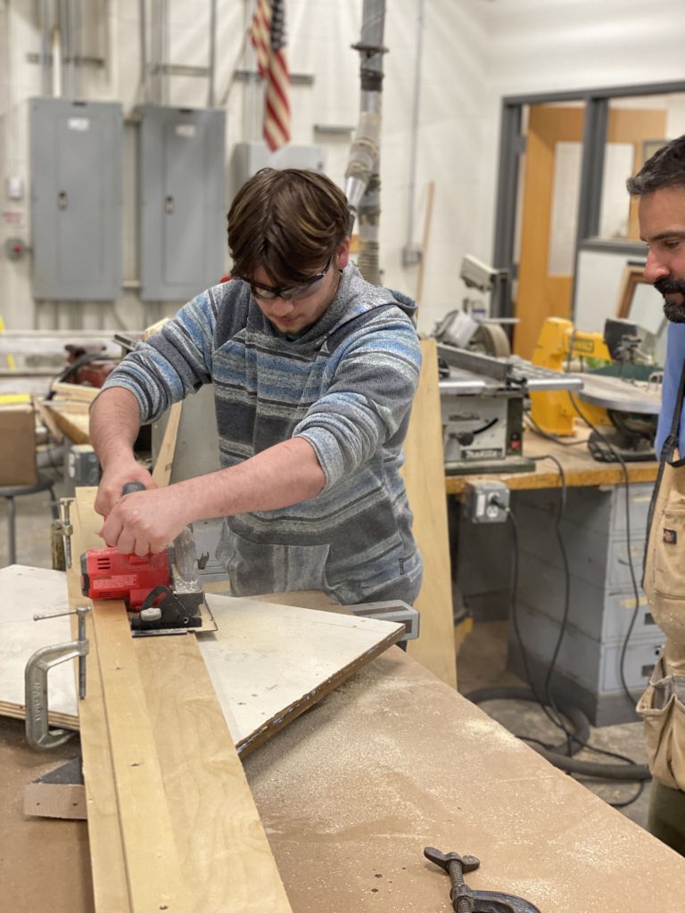 Students using tools and wood