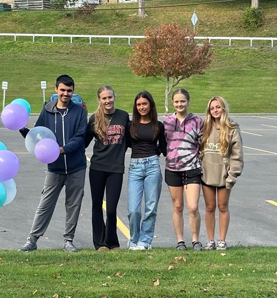 Five Middle-High School students posing outside