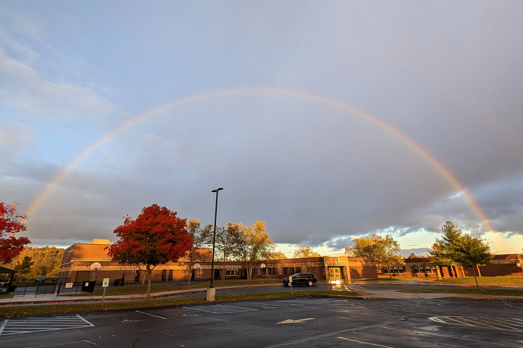 Elementary School building with a rainbow over it