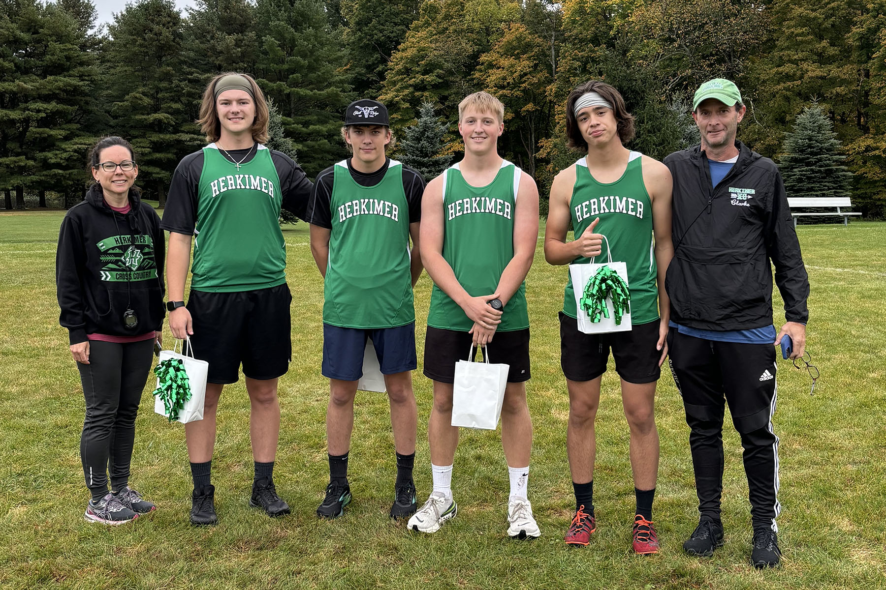 Cross country seniors posing with coaches