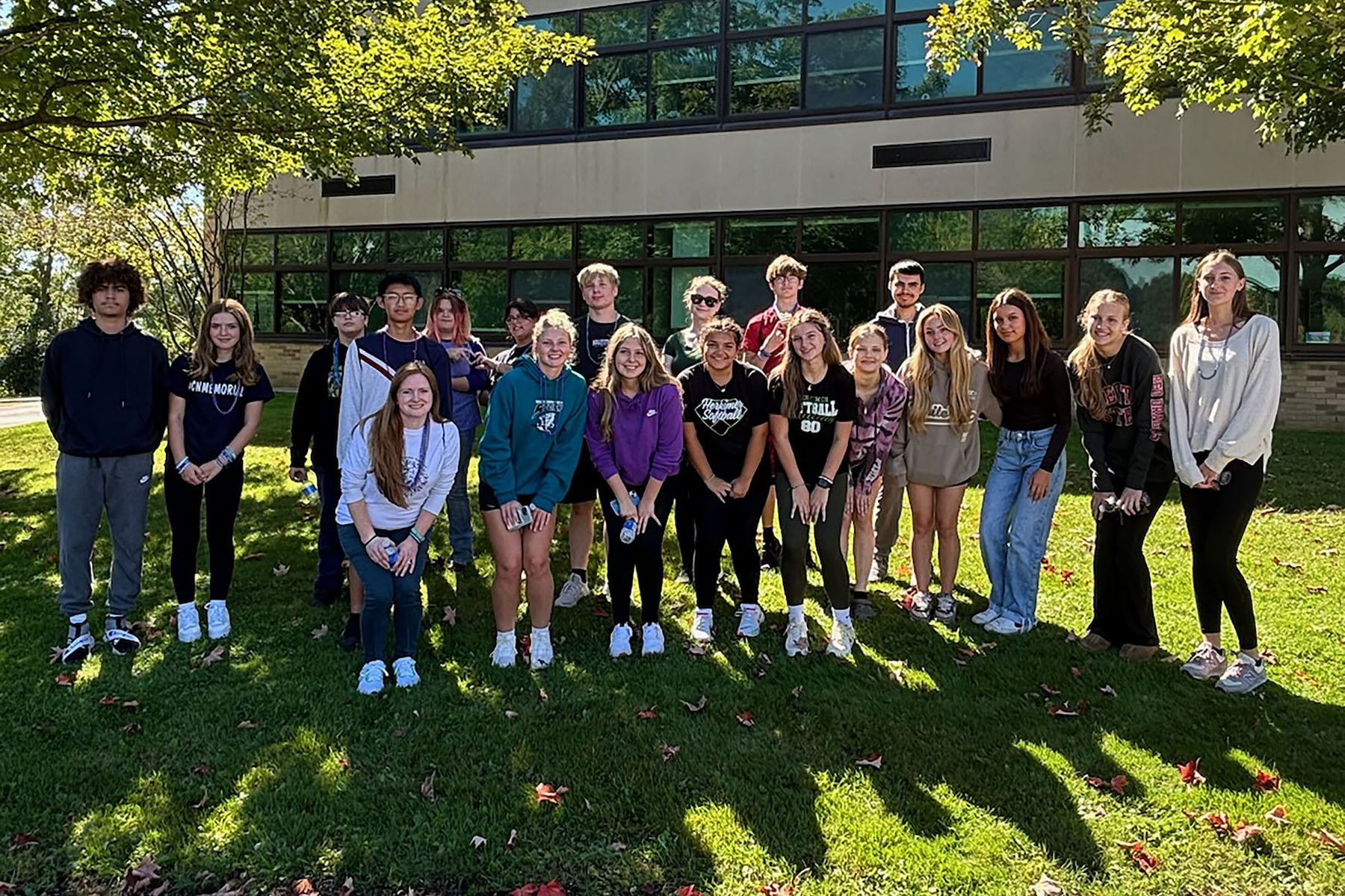 Students who helped with Out of Darkness Walk posing in front of Middle-High School