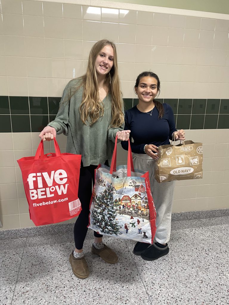 Two high school students holding bags