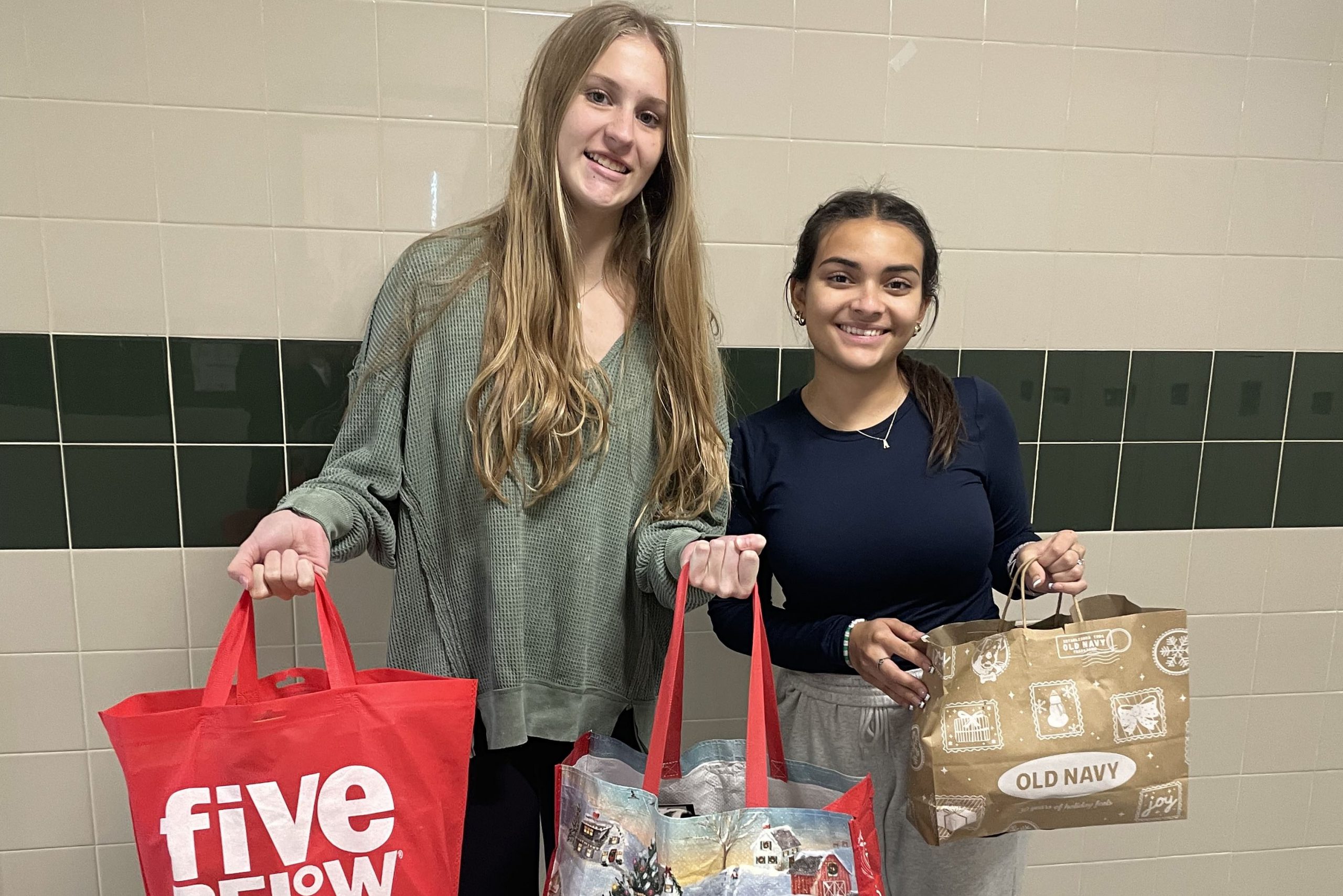 Two students holding bags in support of the Holiday Project