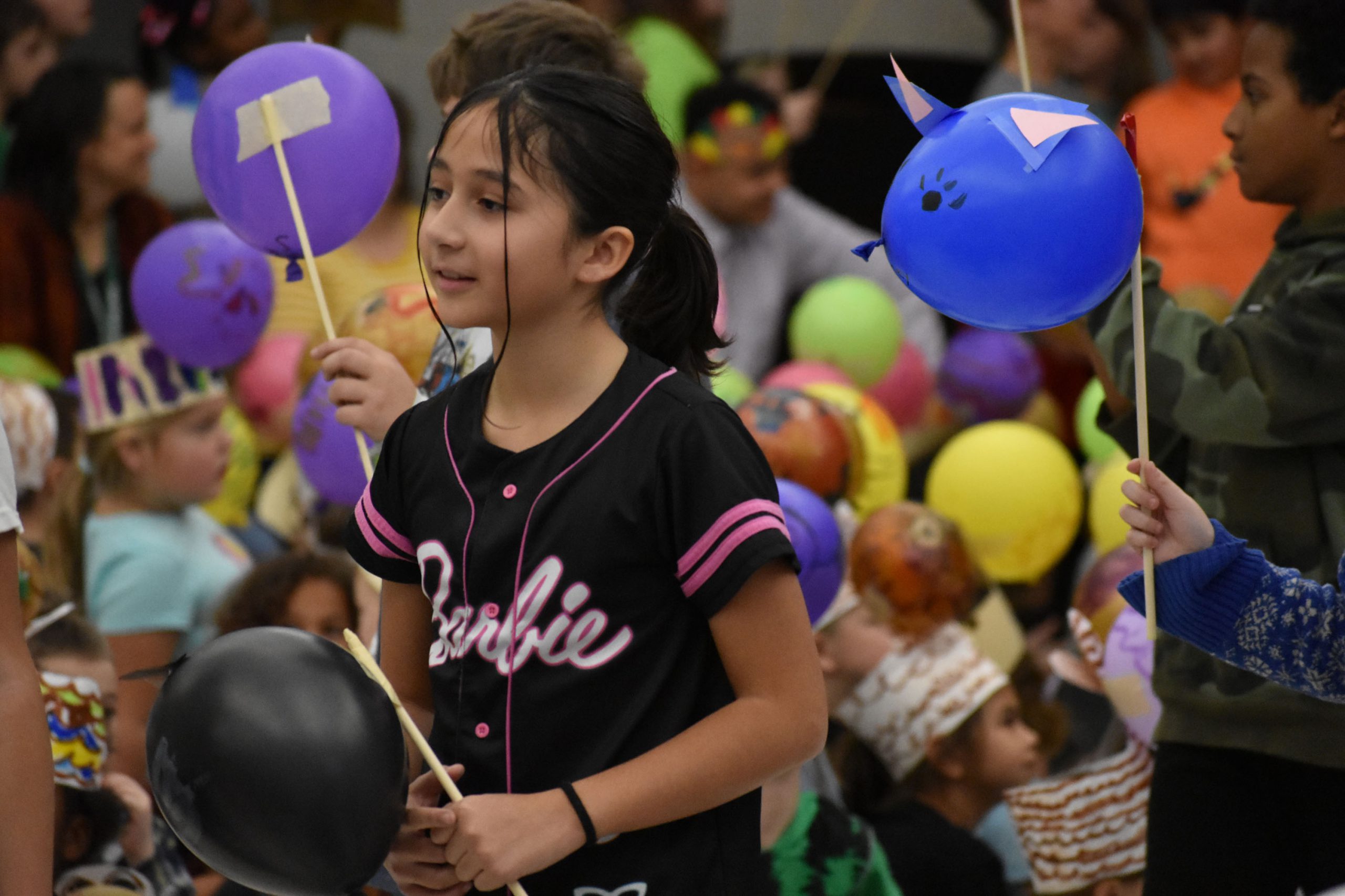 Student holding balloon for Thanksgiving parade