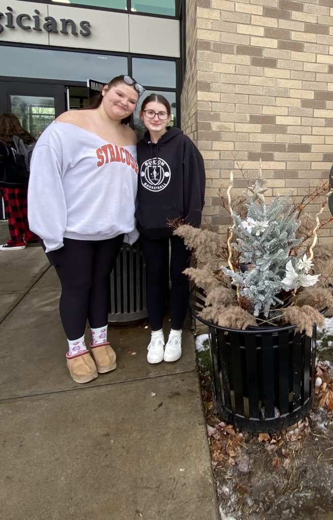 Students posing by seasonal display