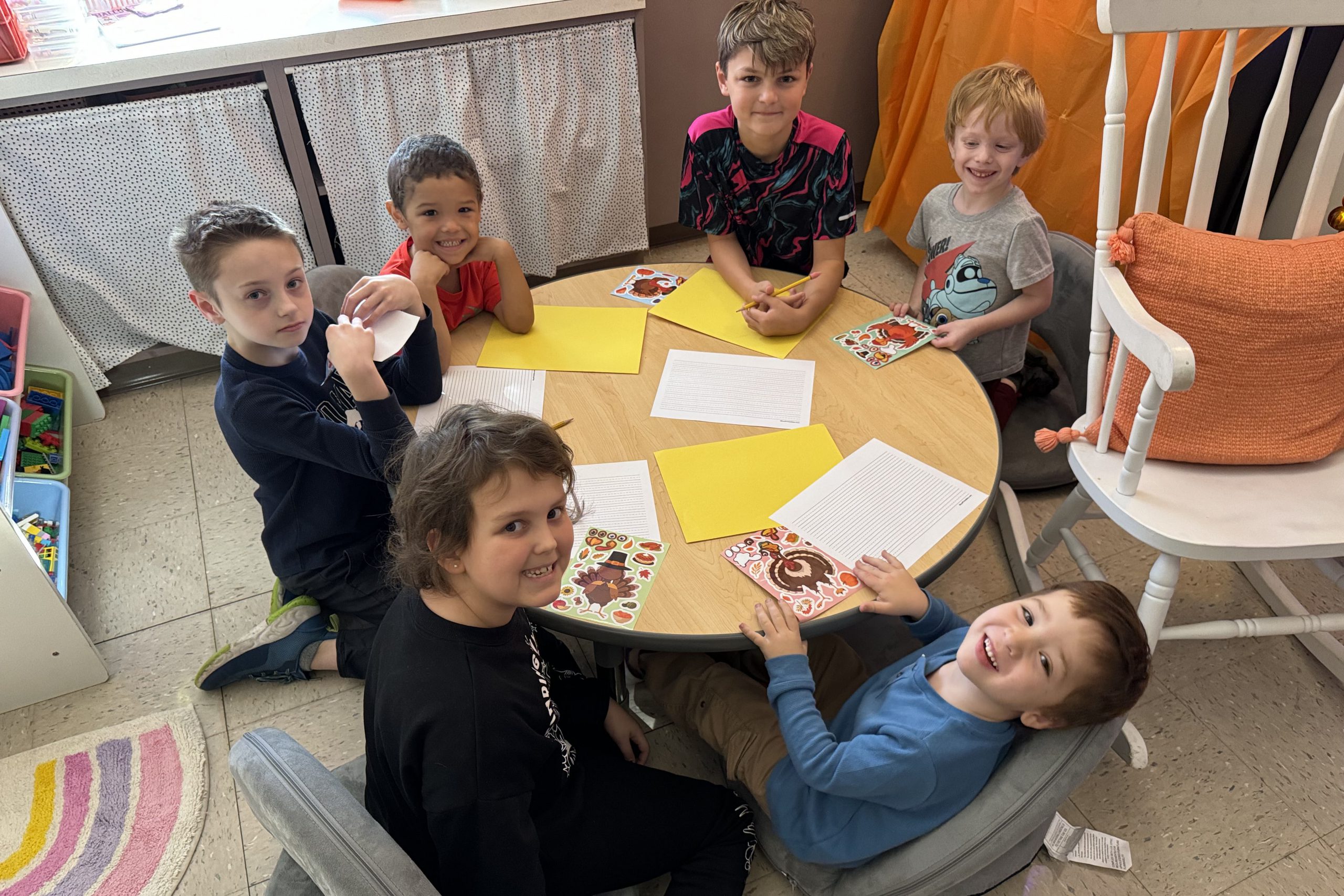 Six students sitting around a table