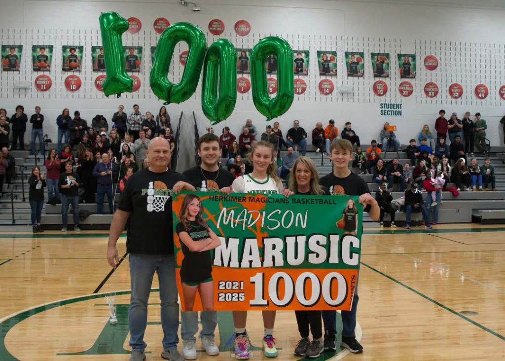 Madison Marusic and family with 1,000 point banner