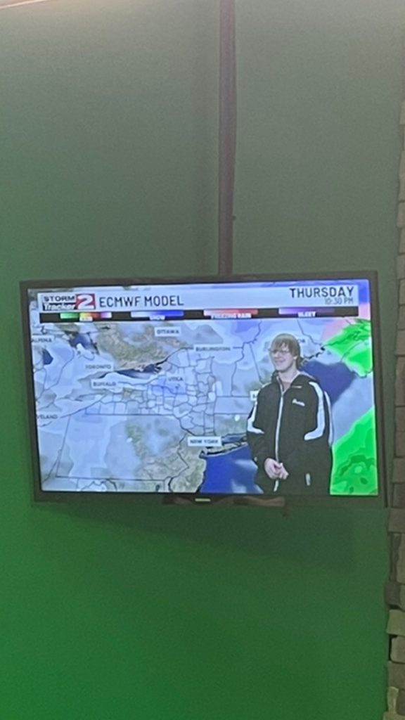 Herkimer junior Arthur Dadello in front of a weather display at WKTV