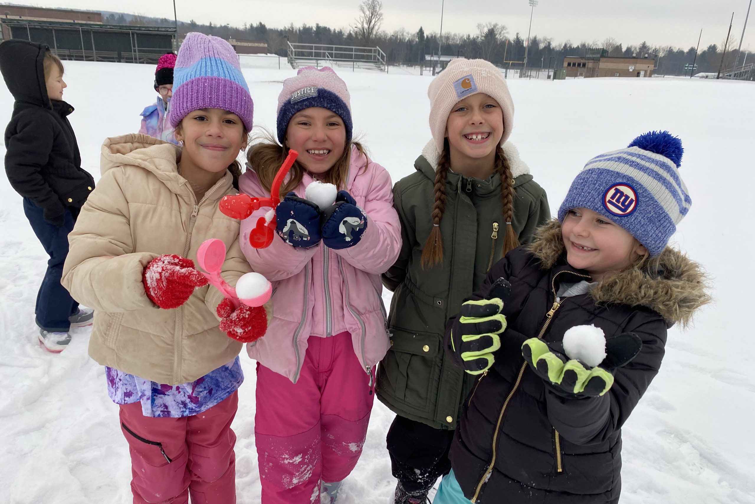 students playing in snow outside