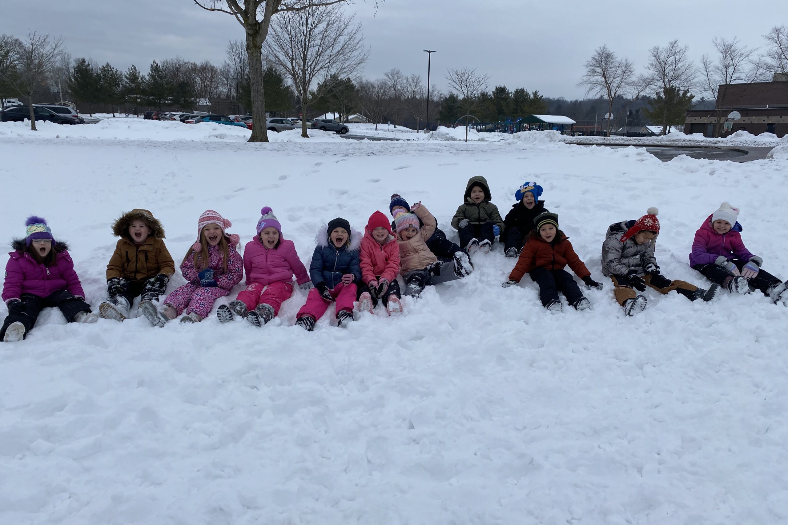 Elementary students playing in the snow