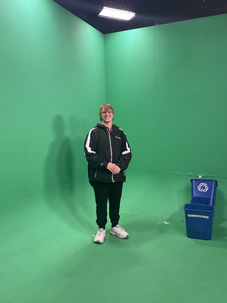 Herkimer junior Arthur Dadello in front of a green screen at WKTV