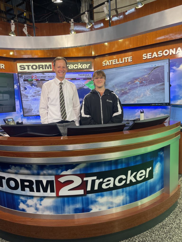 Herkimer junior Arthur Dadello and WKTV meteorologist Bill Kardas on set