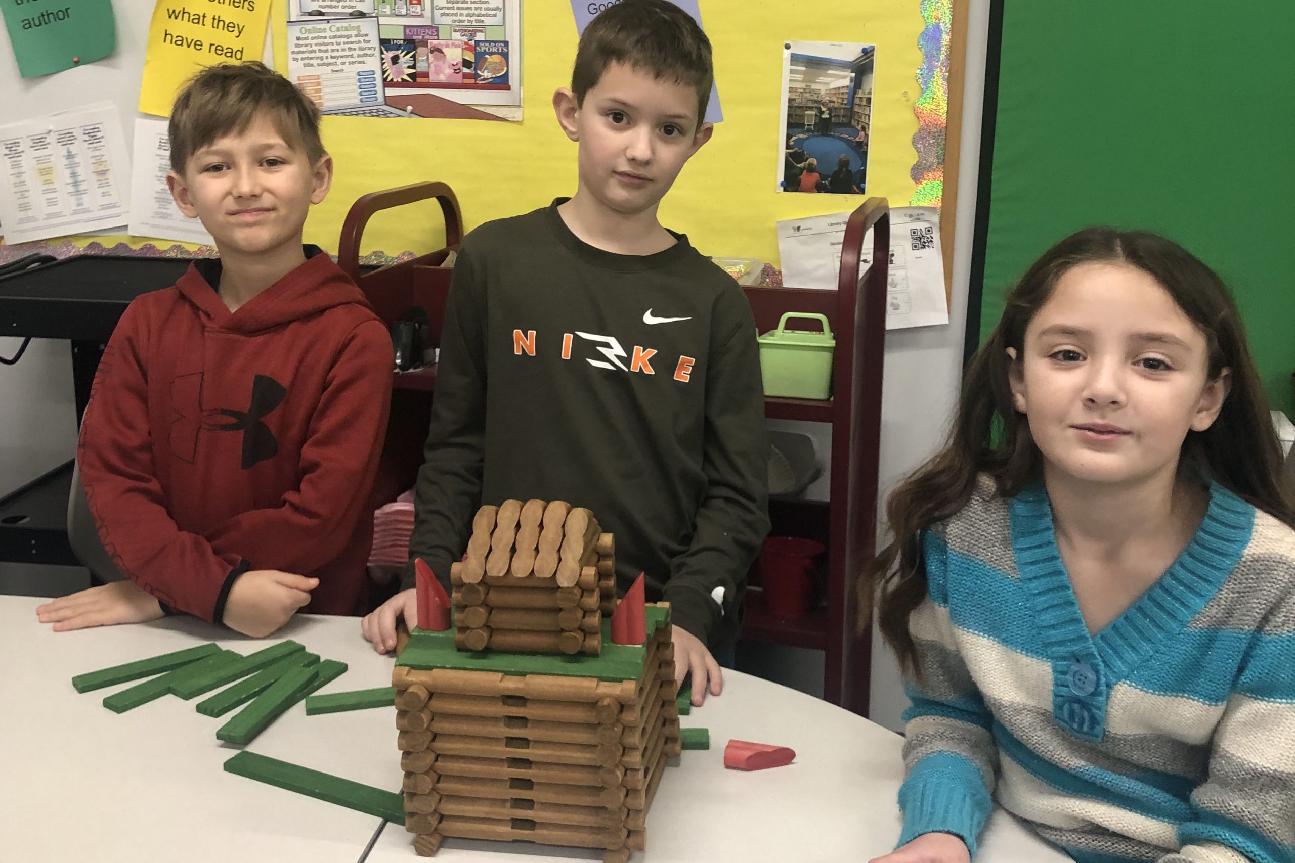 Students building with Lincoln logs