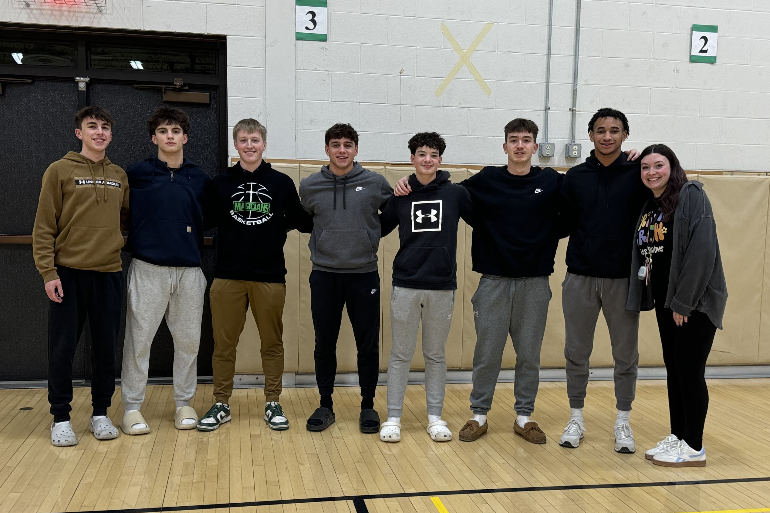 Varsity basketball helping visit elementary school students