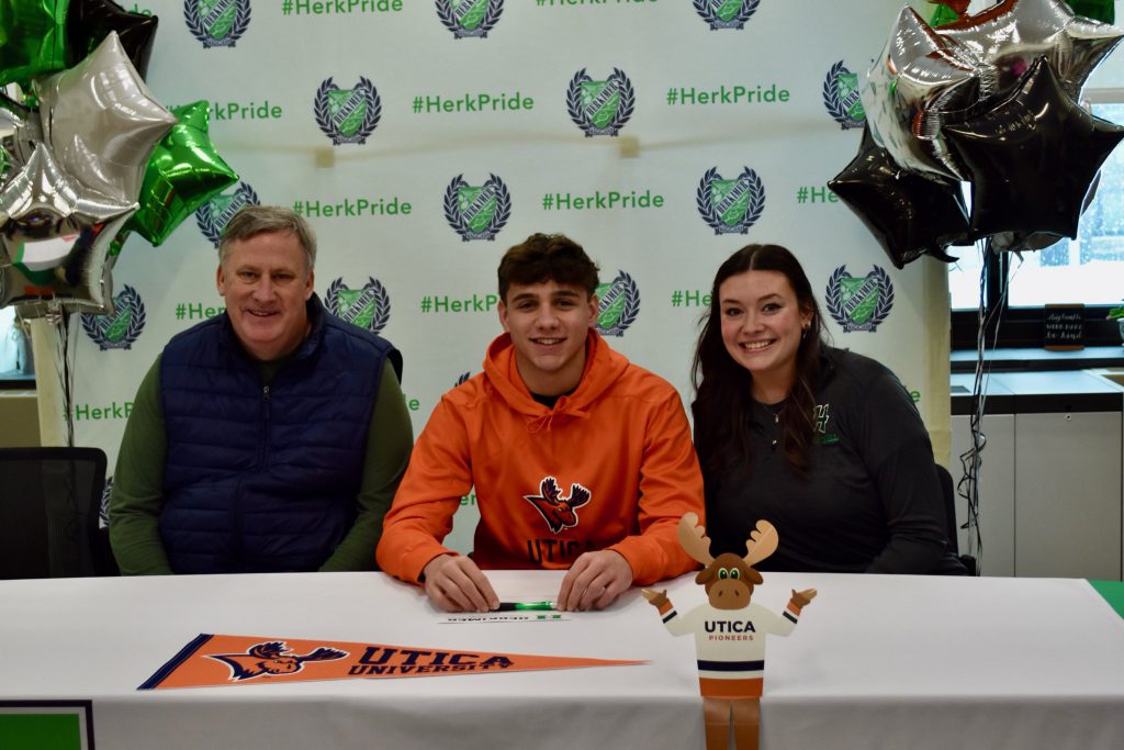 Zachary Petucci with basketball coaches at commitment signing