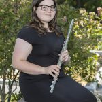 Student Caitlin Berg holding a flute