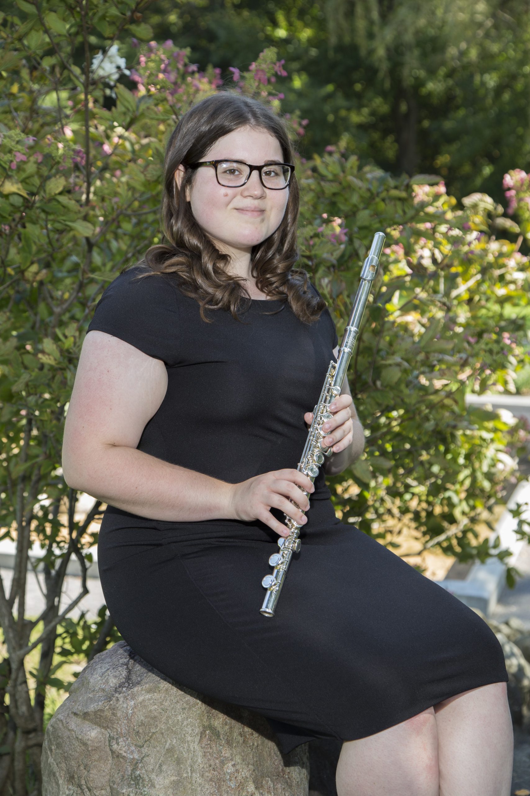 Student Caitlin Berg holding a flute